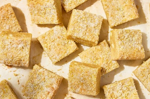 Alex Roberts Lemon Citrus Blondies on parchment paper atop a counter. - select to zoom