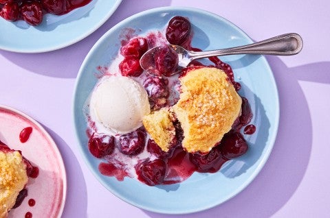 Buttermilk Biscuit Cherry Cobbler on a plate with ice cream - select to zoom