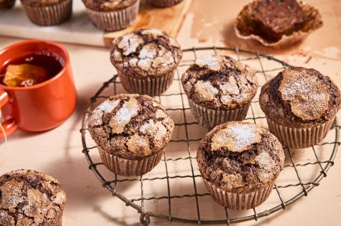 Chocolate Zucchini Muffins on a cooling rack - select to zoom