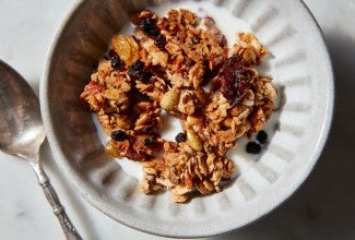 Crunchy granola clusters in a cereal bowl with milk