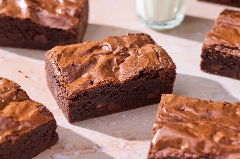 Small-Batch Brownies on a table with a glass of milk - select to zoom